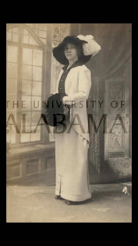 Historic photograph of Jennie C. Lee, Tuskegee Choir director, in a dress with hat and fur muff. 