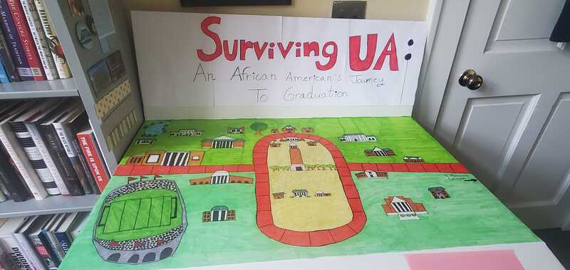 Handmade board game titled Surviving UA with campus rendered on the board.
