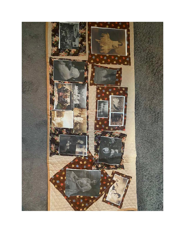 Quilt with tan background, brown print fabric and historic images quilted on the object. 